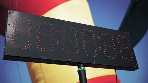 Digital timer. Counter. close-up. black light board, with red numbers of small Stock Footage 165594495