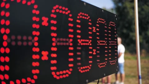 Digital timer. Counter. close-up. black light board, with red numbers of small Vidéo 167540996