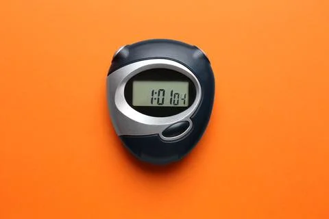 Digital timer on orange background, top view Stock Photos
