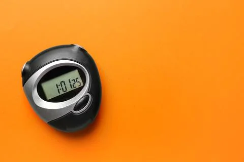 Digital timer on orange background, top view. Space for text Stock Photos