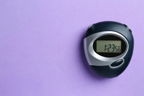 Digital timer on violet background, top view. Space for text Stock Photos