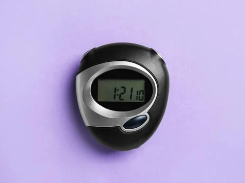 Digital timer on violet background, top view Stock Photos