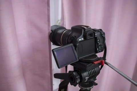 Digital video camera hidden behind pink curtains, spying neighbors Peeping... Stock Photos
