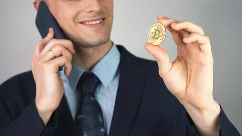 Digital virtual currency concept and symbol. Man is holding and buying, selling  Stock Footage 125253091