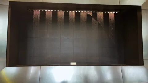 Digital water clock prints time and intricate patterns at Osaka Station.  Stock Footage 335463149