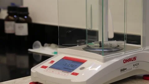 Digital Weight Scale measuring the weight of a syringe on a research lab Stock-Footage 155118225