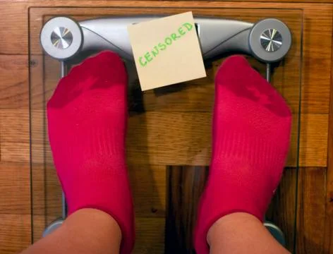 Digital weight scale with post it note covering screen Stock Photos