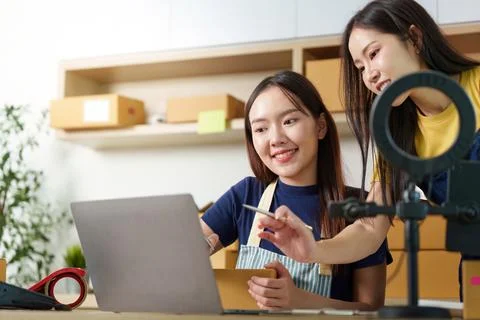 Digital Workspace. Women collaborating on e-commerce projects using a laptop. Stock Photos