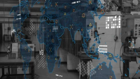 Digital world map overlay floating above industrial workshop featuring hex grid Stock Footage 307436303