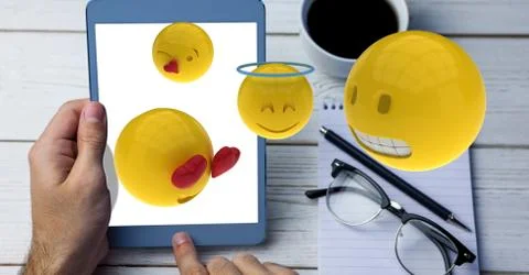 Digitally generated image of emojis flying over hand using tablet computer by Stock-Fotos