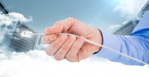 Digitally generated image of hand holding cable with flare against servers Stock Photos