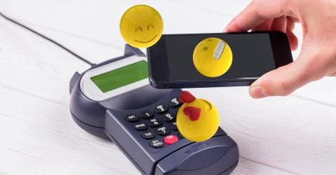 Digitally generated image of hand holding smart phone over credit card reader Stock Photos