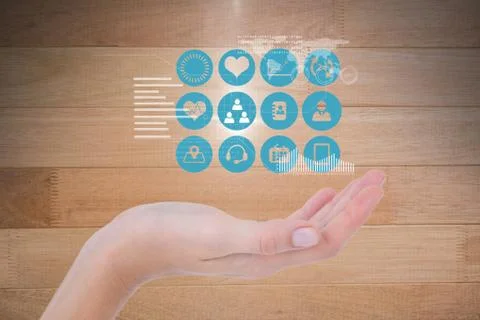 Digitally generated image of various icons over hand against wooden wall Stock Photos