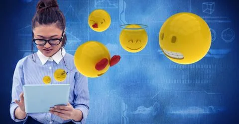 Digitally generated image of woman using tablet computer with emojis flying Stock Photos