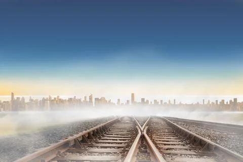 Digitally generated railway tracks leading to city on the horizon Ilustración de archivo
