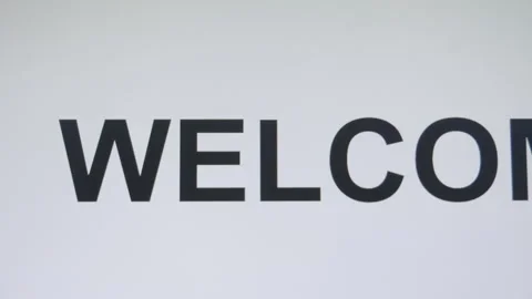 Digitally typing the word welcome in an upper case font, with the use of a Video stock 255553345