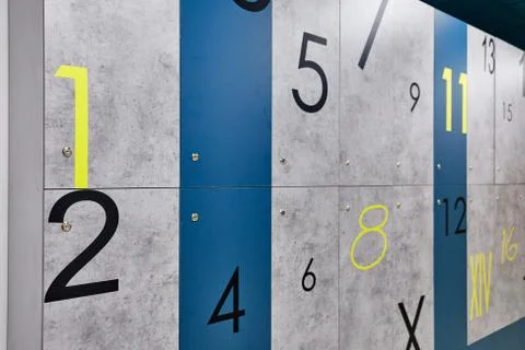 Digits of different sizes, in order, from one to sixteen on gray and blue plates Stock Photos