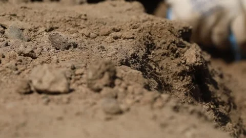 Digs the ground with a tool 6 Stock Footage 323791838