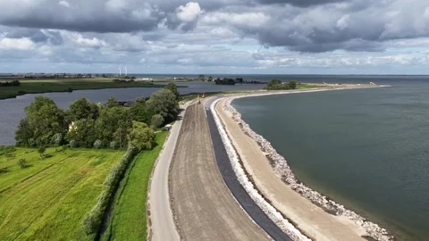 Dike reinforcement construction for coastal flood defense Stock Footage 337779949