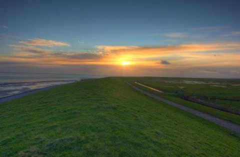 Dike at sunset Stock Photos