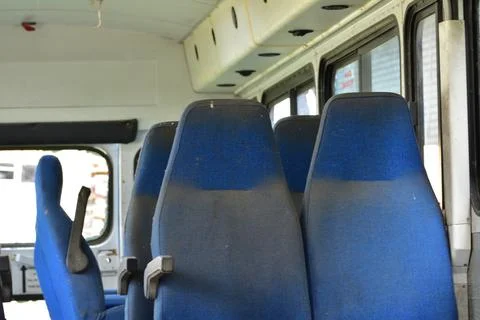 Dilapidated and rusty bus with broken windows in a remote area. Scrap. Stock Photos