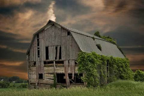 Dilapidated barn at sunset Stock Photos