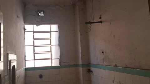 Dilapidated bathroom interior with grimy white tiles and motion video footage Stock Footage 339248163