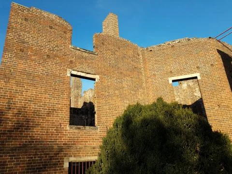 Dilapidated brick house or structure in ruins Stock Photos