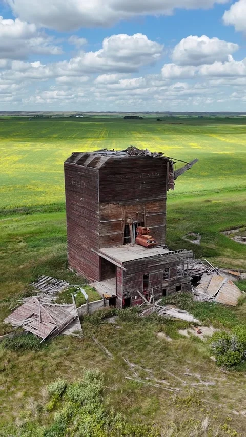 Dilapidated grain elevator with a red car parked on the roof Stock Footage 313810564