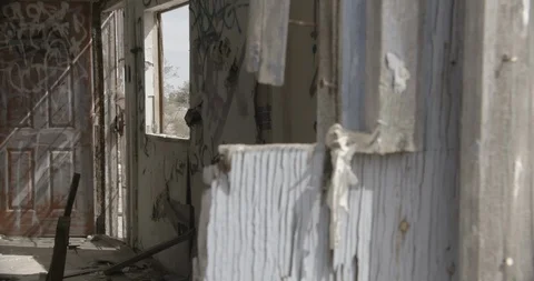 Dilapidated House Interior Front Room and Graffiti and Exterior Wall - Pan Left Stock Footage 89941973