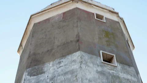 Dilapidated structure of an old lighthouse full of graffiti, tilt view bottom up Stock Footage 101225580