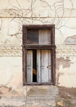 Dilapidated window on the cracked wall Stock Photos