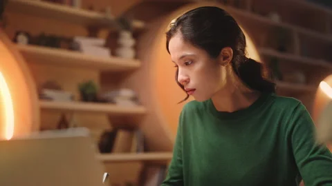 Diligent Asian female student studying in library, taking notes and reading book Stock Footage 340961349