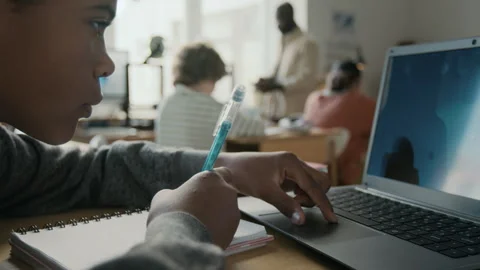 Diligent Boy Writing in Notebook and Using Laptop During 3D Modelling Class Stock Footage 301912200
