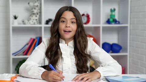 Diligent kid writing at school online video lesson hold pen, september Stock Footage 220164564