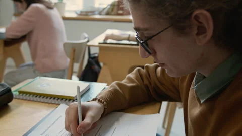 Diligent Nerdy Male School Student Performing Multiple Choice Test at Lesson Stock Footage 333731386