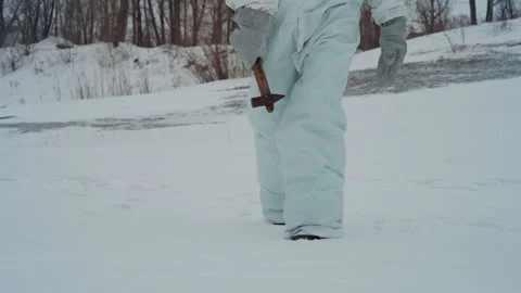 Diligent scientist progressing through snowcovered river edge. Dedicated Stock Footage 346471368