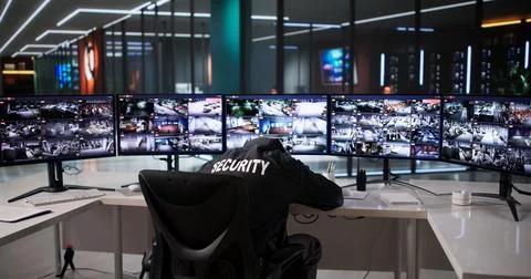 Diligent Security Guard Monitors CCTV System On Computer Screen Stock Photos