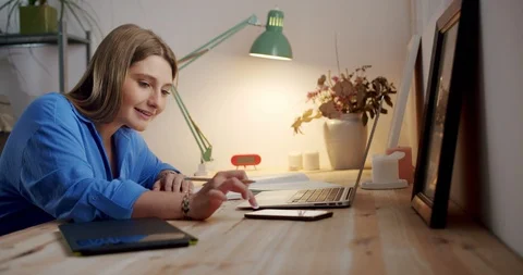 Diligent young female making notes writing in notebook enjoying staying online Video stock 119385051