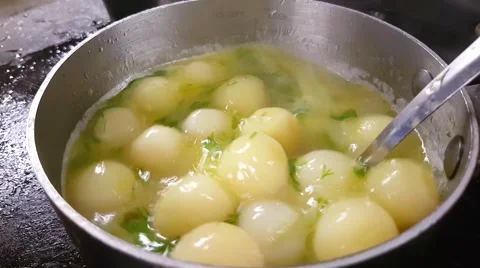 Dill - butter boiling and blending parisian potatoes, in slow motion, in a me Stock Footage 63384149