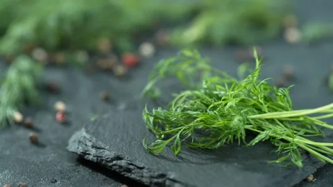 Dill herb falling slow motion to the black table 4k Stock Footage 131734620