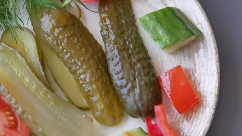 Dill pickles and fresh vegetables on a plate, close-up macro shot showcasin.. Stock Footage 333152722