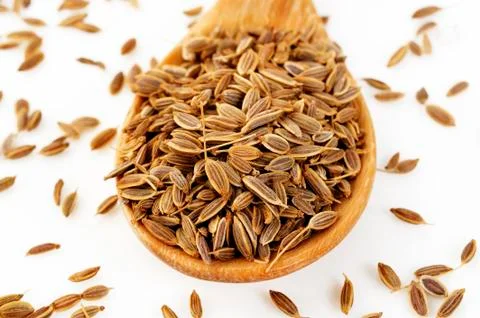 Dill seeds in spoon Stock Photos
