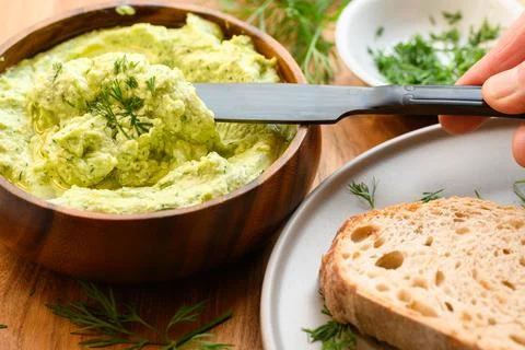Dill spread getting spread on a slice of bread Stock Photos