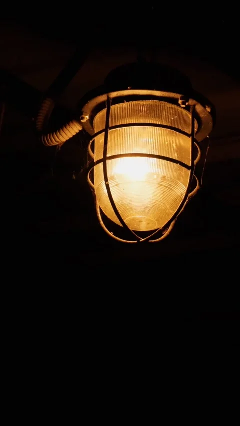 A dim lantern burning in the pitch darkness. Vertical video, shorts. Video stock 285305052