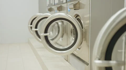 Dim Laundry Room Drying Machines Open As Light Turns On Stock Footage 318838393