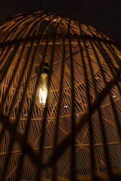 Dim light from a bulb at night to save energy. Energy crisis concept Stock Photos