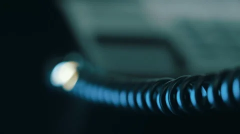 In the dim light the camera moves along the twisted wires from the handset Video stock 56259193