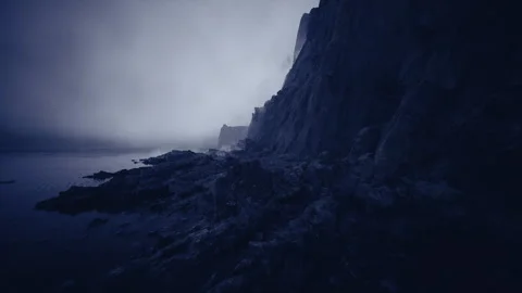 Dim light enhances rocky edge profiles and thick fog rolling ashore Stock Footage 341833084