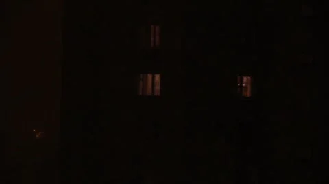 Dim light from house windows through night snowfall Stock-Footage 2103358